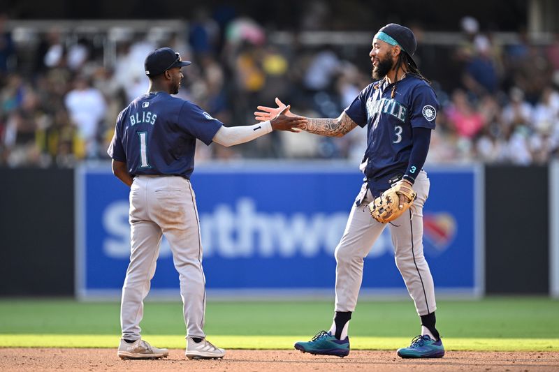 Jul 10, 2024; San Diego, California, USA; Seattle Mariners shortstop J.P. Crawford (3) and second baseman Ryan Bliss (1) celebrate on the field after defeating the San Diego Padres at Petco Park. Mandatory Credit: Orlando Ramirez-USA TODAY Sports