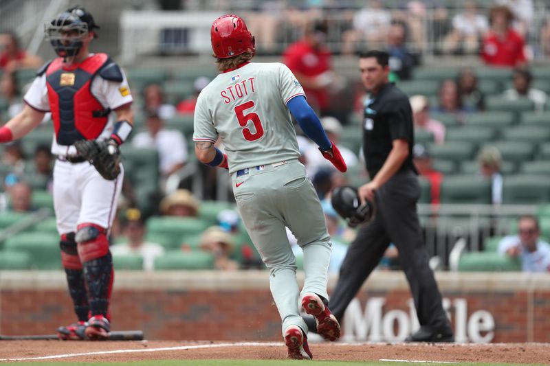 Jun 29, 2025; Cumberland, Georgia, Philadelphia Phillies second baseman Bryson Stott (5) scores a run during a game against the Atlanta Braves during the fifth inning at Truist Park. Mandatory Credit: Mady Mertens-Imagn Images
