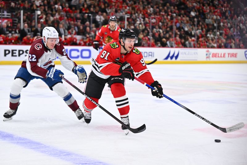 Dec 19, 2023; Chicago, Illinois, USA; Chicago Blackhawks forward Anthony Beauvillier (91) controls the puck in front of Colorado Avalanche forward Fredrik Olofsson (22) in the third period at United Center. Mandatory Credit: Jamie Sabau-USA TODAY Sports