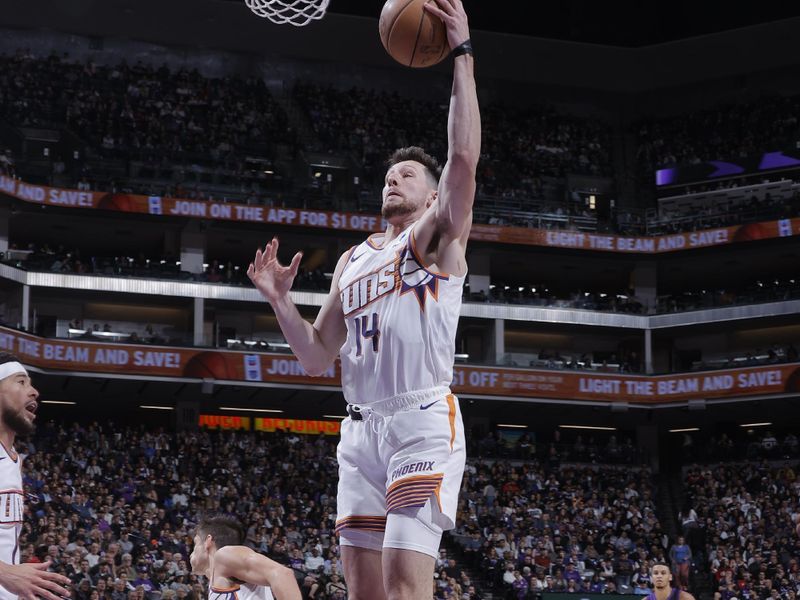 SACRAMENTO, CA - APRIL 12: Drew Eubanks #14 of the Phoenix Suns grabs a rebound during the game against the Sacramento Kings on April 12, 2024 at Golden 1 Center in Sacramento, California. NOTE TO USER: User expressly acknowledges and agrees that, by downloading and or using this Photograph, user is consenting to the terms and conditions of the Getty Images License Agreement. Mandatory Copyright Notice: Copyright 2024 NBAE (Photo by Rocky Widner/NBAE via Getty Images)