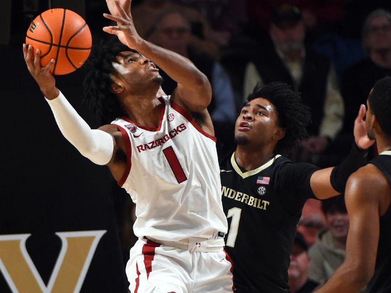 Jan 14, 2023; Nashville, Tennessee, USA; Arkansas Razorbacks guard Ricky Council IV (1) shoots in the lane against Vanderbilt Commodores forward Colin Smith (1) during the first half at Memorial Gymnasium. Mandatory Credit: Christopher Hanewinckel-USA TODAY Sports