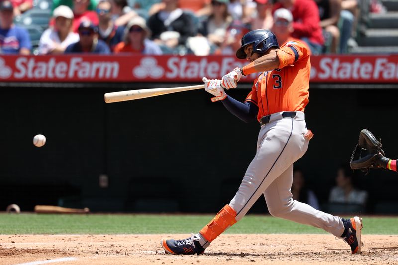 Jun 9, 2024; Anaheim, California, USA;  Houston Astros shortstop Jeremy Pena (3) hits an RBI single during the third inning against the Los Angeles Angels at Angel Stadium. Mandatory Credit: Kiyoshi Mio-USA TODAY Sports