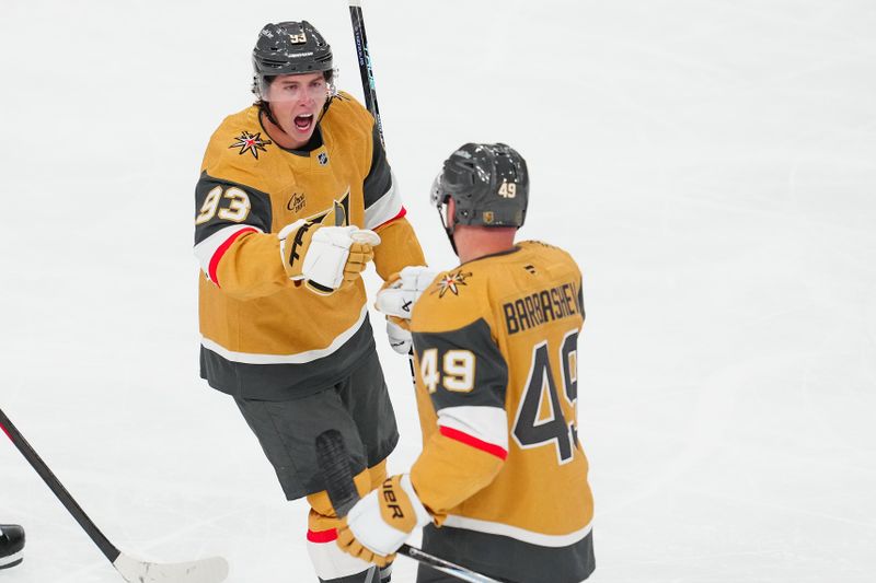 Oct 8, 2025; Las Vegas, Nevada, USA; Vegas Golden Knights right wing Mitch Marner (93) celebrates with Vegas Golden Knights left wing Ivan Barbashev (49) after assisting on a goal scored by Barbabshev against the Los Angeles Kings during the third period at T-Mobile Arena. Mandatory Credit: Stephen R. Sylvanie-Imagn Images