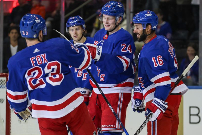 Sep 26, 2023; New York, New York, USA;  New York Rangers right wing Kaapo Kakko (24) celebrates with his teammates after scoring a goal in the first period against the New York Islanders at Madison Square Garden. Mandatory Credit: Wendell Cruz-USA TODAY Sports