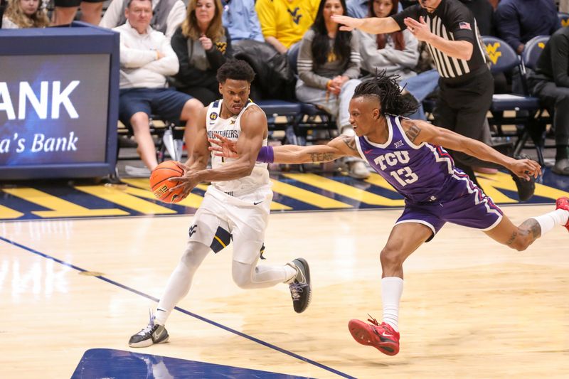 Feb 25, 2025; Morgantown, West Virginia, USA; West Virginia Mountaineers guard Joseph Yesufu (1) and TCU Horned Frogs forward Trazarien White (13) go for a loose ball during the second half at WVU Coliseum. Mandatory Credit: Ben Queen-Imagn Images