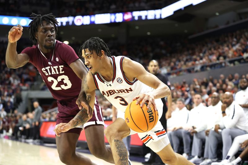 Jan 14, 2025; Auburn, Alabama, USA;  Auburn Tigers forward Jahki Howard (3) is blocked by Auburn Tigers forward Addarin Scott (23) during the second half at Neville Arena. Mandatory Credit: John Reed-Imagn Images