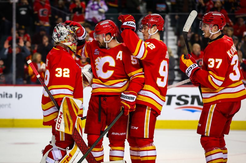Jan 31, 2026; Calgary, Alberta, CAN; Calgary Flames goaltender Dustin Wolf (32) celebrates win with teammates after defeating the San Jose Sharks at Scotiabank Saddledome. Mandatory Credit: Sergei Belski-Imagn Images