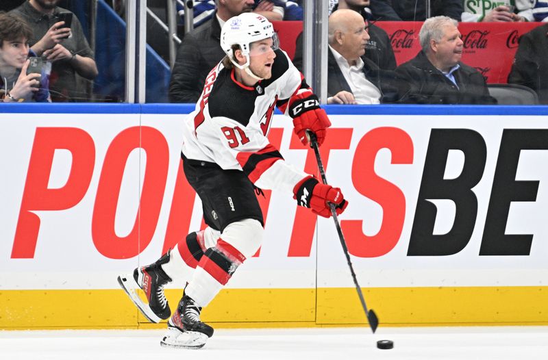 Apr 11, 2024; Toronto, Ontario, CAN; New Jersey Devils forward Dawson Mercer (91) plays a pass against the Toronto Maple Leafs in the first period at Scotiabank Arena. Mandatory Credit: Dan Hamilton-USA TODAY Sports