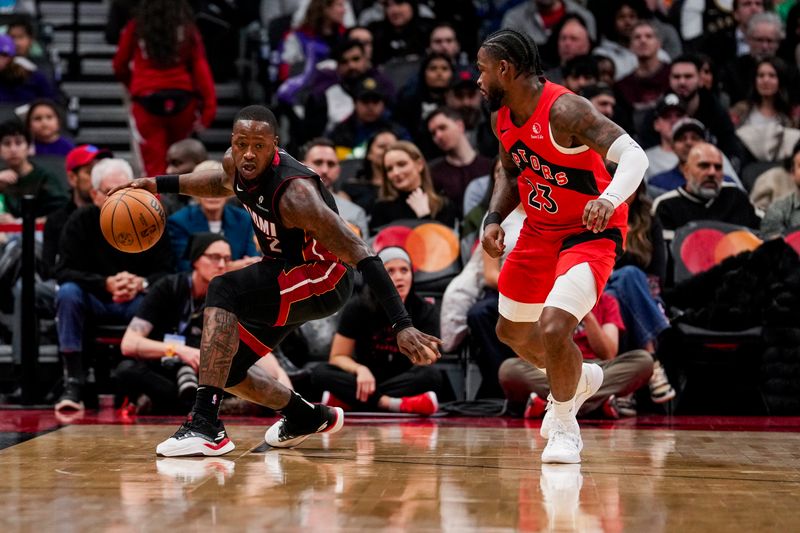 TORONTO, ON - DECEMBER 1: Terry Rozier #2 of the Miami Heat dribbles the ball against Jamal Shead #23 of the Toronto Raptors at Scotiabank Arena on December 1, 2024 in Toronto, Ontario, Canada. NOTE TO USER: User expressly acknowledges and agrees that, by downloading and/or using this Photograph, user is consenting to the terms and conditions of the Getty Images License Agreement. (Photo by Andrew Lahodynskyj/Getty Images)