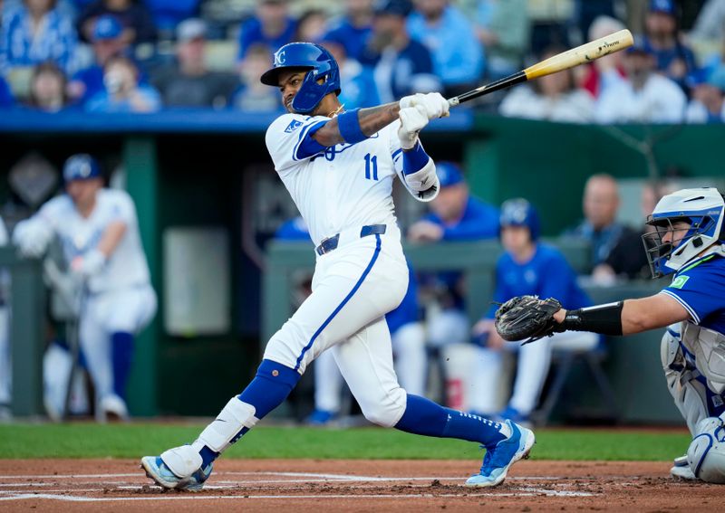 Apr 23, 2024; Kansas City, Missouri, USA; Kansas City Royals third base Maikel Garcia (11) hits a single against the Toronto Blue Jays during the first inning at Kauffman Stadium. Mandatory Credit: Jay Biggerstaff-USA TODAY Sports