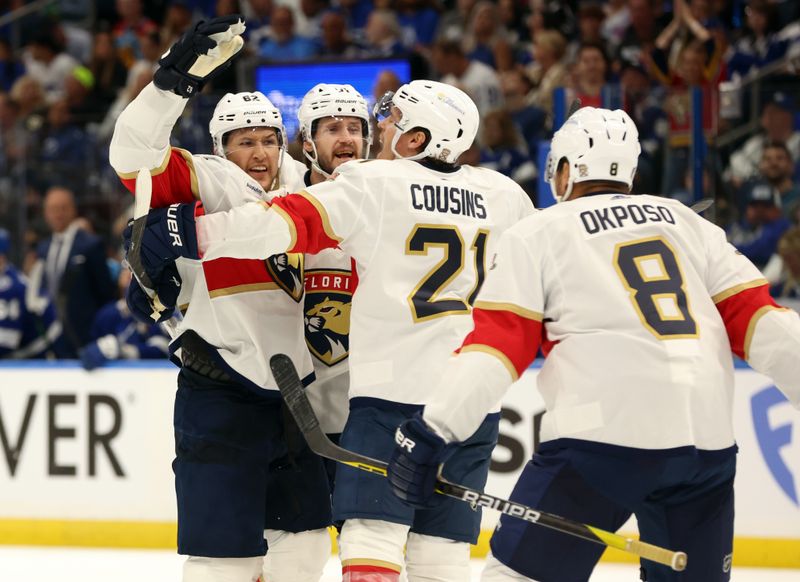 Apr 25, 2024; Tampa, Florida, USA; Florida Panthers defenseman Brandon Montour (62) is congratulated by   center Nick Cousins (21), right wing Kyle Okposo (8) and defenseman Oliver Ekman-Larsson (91) after he scored a goal against the Tampa Bay Lightning  during the second period in game three of the first round of the 2024 Stanley Cup Playoffs at Amalie Arena. Mandatory Credit: Kim Klement Neitzel-USA TODAY Sports