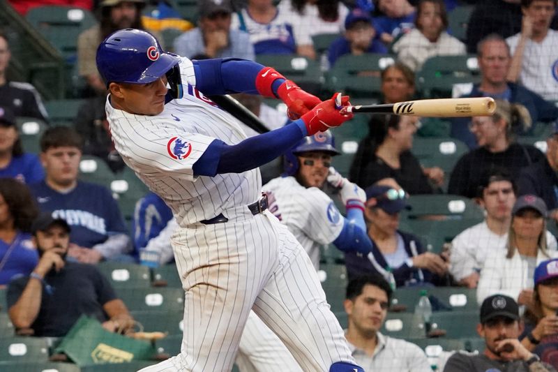 Sep 22, 2024; Chicago, Illinois, USA; Chicago Cubs catcher Miguel Amaya (9) hits a double against the Washington Nationals during the sixth inning at Wrigley Field. Mandatory Credit: David Banks-Imagn Images