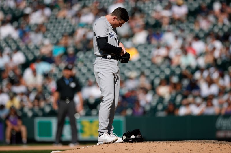 Jul 16, 2023; Denver, Colorado, USA; New York Yankees relief pitcher Ron Marinaccio (97) adjusts his pitch-com after a pitching violation in the eleventh inning against the Colorado Rockies at Coors Field. Mandatory Credit: Isaiah J. Downing-USA TODAY Sports