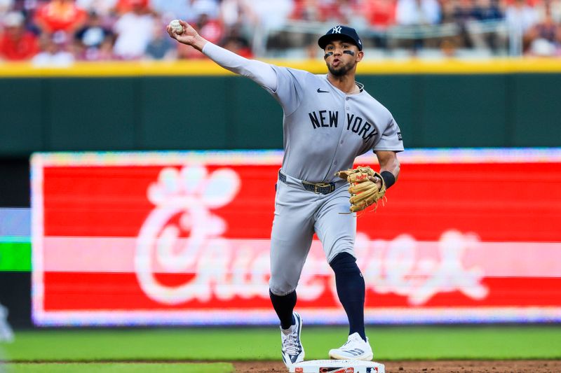 Jun 24, 2025; Cincinnati, Ohio, USA; New York Yankees second baseman Oswald Peraza (18) throws to first to get Cincinnati Reds third baseman Santiago Espinal (not pictured) out in the third inning at Great American Ball Park. Mandatory Credit: Katie Stratman-Imagn Images