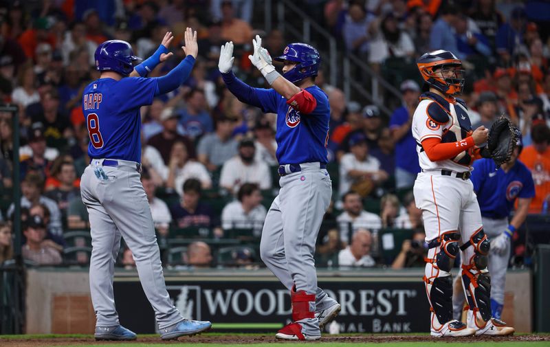 May 17, 2023; Houston, Texas, USA; Houston Astros catcher Yainer Diaz (21) looks on as Chicago Cubs right fielder Seiya Suzuki (27) celebrates with left fielder Ian Happ (8) after hitting a home run during the third inning at Minute Maid Park. Mandatory Credit: Troy Taormina-USA TODAY Sports