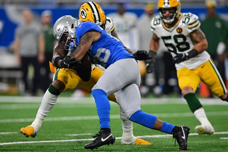 Detroit Lions running back Jahmyr Gibbs is tackle day Green Bay Packers linebacker Quay Walker during the second half of an NFL football game, Thursday, Nov. 23, 2023, in Detroit. The Packers won 29-22. (AP Photo/David Dermer)