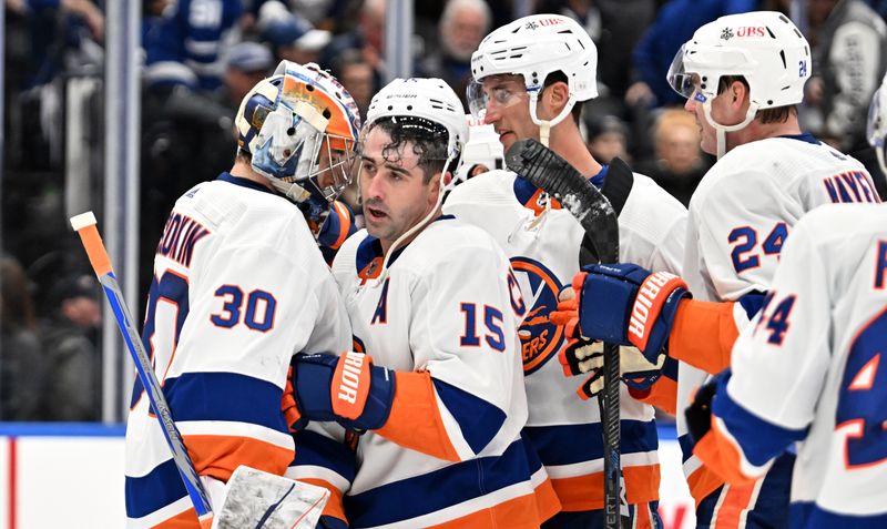 Feb 5, 2024; Toronto, Ontario, CAN;   New York Islanders goalie Ilya Sorokin (30) is greeted by forward Cal Clutterbuck (15) and team mates as they celebrate a win over the Toronto Maple Leafs at Scotiabank Arena. Mandatory Credit: Dan Hamilton-USA TODAY Sports