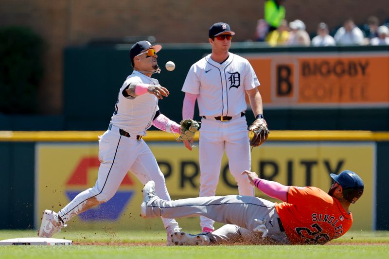 May 12, 2024; Detroit, Michigan, USA;  Detroit Tigers shortstop Javier Baez (28) makes a throw to first to complete a double play as Houston Astros first baseman Jon Singleton (28) slides into second in the second inning at Comerica Park. Mandatory Credit: Rick Osentoski-USA TODAY Sports
