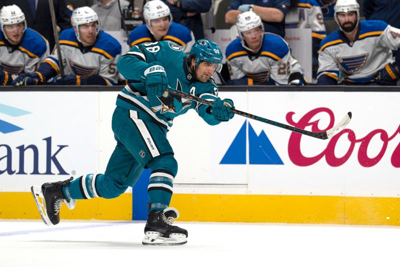 Oct 10, 2024; San Jose, California, USA; San Jose Sharks defenseman Mario Ferraro (38) shoots the puck during the first period against the St. Louis Blues at SAP Center at San Jose. Mandatory Credit: Stan Szeto-Imagn Images