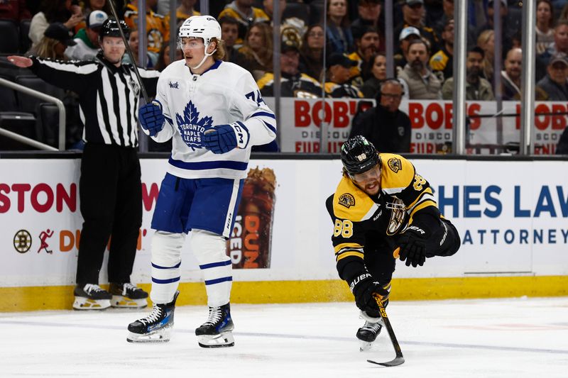 Oct 26, 2024; Boston, Massachusetts, USA; Toronto Maple Leafs center Bobby McMann (74) knocks down Boston Bruins right wing David Pastrnak (88) as he skates by during the first period at TD Garden. Mandatory Credit: Winslow Townson-Imagn Images