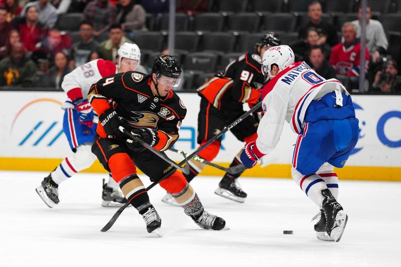 Nov 22, 2023; Anaheim, California, USA; Anaheim Ducks defenseman Cam Fowler (4) skates with the puck against Montreal Canadiens defenseman Mike Matheson (8) in the second period at Honda Center. Mandatory Credit: Kirby Lee-USA TODAY Sports