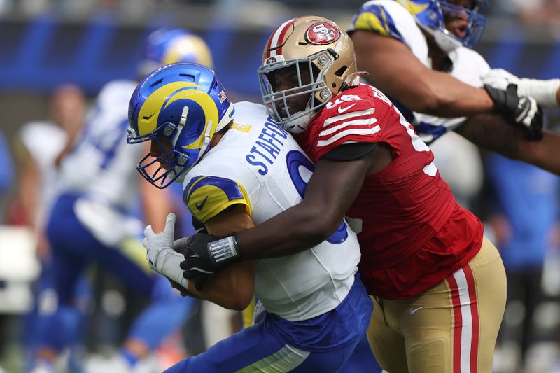 San Francisco 49ers defensive tackle Javon Hargrave, right, sacks Los Angeles Rams quarterback Matthew Stafford during the first half of an NFL football game, Sunday, Sept. 22, 2024, in Inglewood, Calif. (AP Photo/Ryan Sun)