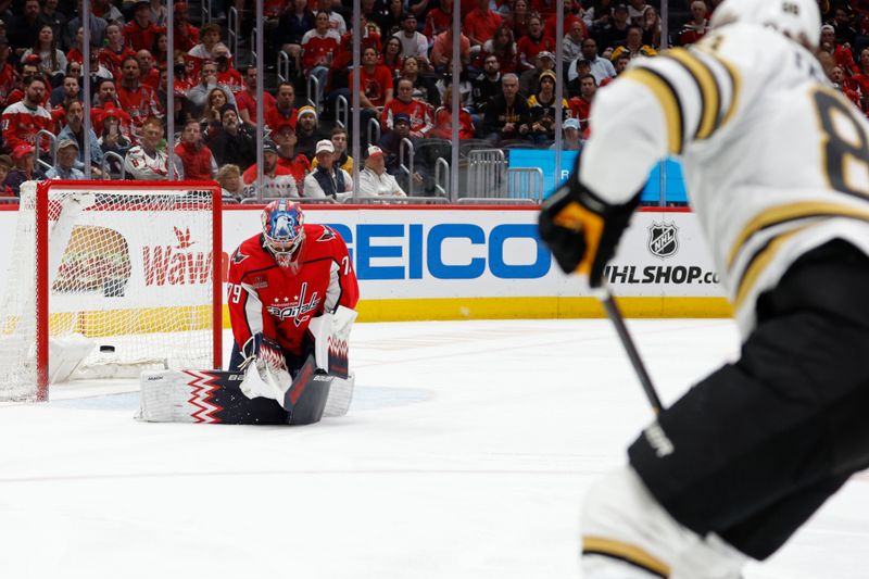 Apr 15, 2024; Washington, District of Columbia, USA; Washington Capitals goaltender Charlie Lindgren (79) makes a save on Boston Bruins right wing David Pastrnak (88) in the second period at Capital One Arena. Mandatory Credit: Geoff Burke-USA TODAY Sports