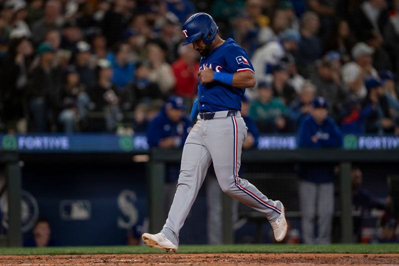 Jun 15, 2024; Seattle, Washington, USA; Texas Rangers third baseman Ezequiel Duran (20) scores a run during the fifth inning against the Seattle Mariners at T-Mobile Park. Mandatory Credit: Stephen Brashear-USA TODAY Sports