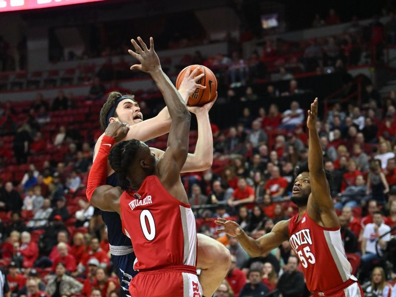 Jan 28, 2023; Las Vegas, Nevada, USA; Nevada Wolf Pack center Will Baker (50) drives to the net on UNLV Runnin' Rebels forward Victor Iwuakor (0) in the first half at Thomas & Mack Center. Mandatory Credit: Candice Ward-USA TODAY Sports