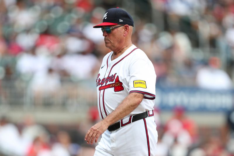 Aug 4, 2024; Cumberland, Georgia, USA; Atlanta Braves manager Brian Snitker (43) walks off the mound in a game against the Miami Marlins in the forth inning at Truist Park. Mandatory Credit: Mady Mertens-USA TODAY Sports