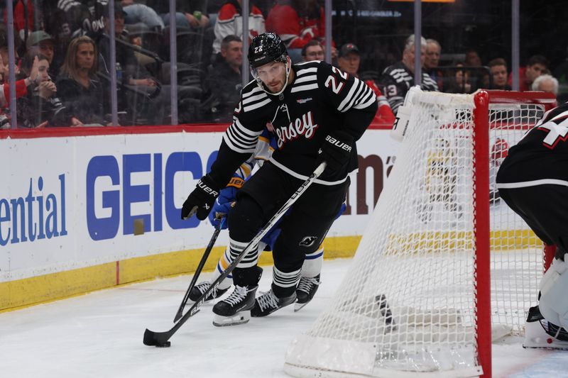 Dec 21, 2025; Newark, New Jersey, USA;  New Jersey Devils defenseman Brett Pesce (22) skates with the puck against the Buffalo Sabres during the first period at Prudential Center. Mandatory Credit: Thomas Salus-Imagn Images