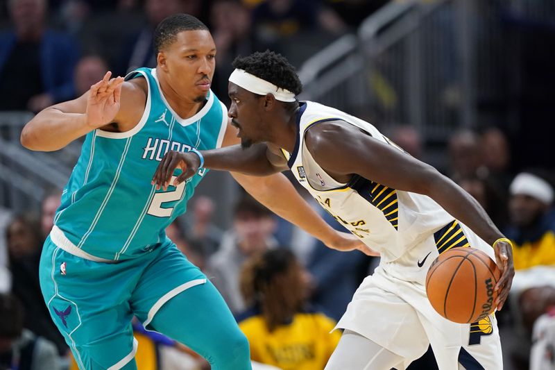 INDIANAPOLIS, INDIANA - OCTOBER 17: Pascal Siakam #43 of the Indiana Pacers dribbles the ball while being guarded by Grant Williams #2 of the Charlotte Hornets in the second quarter during a preseason game at Gainbridge Fieldhouse on October 17, 2024 in Indianapolis, Indiana. NOTE TO USER: User expressly acknowledges and agrees that, by downloading and or using this photograph, User is consenting to the terms and conditions of the Getty Images License Agreement. (Photo by Dylan Buell/Getty Images)