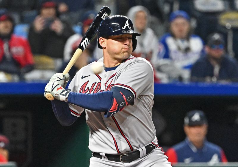 Apr 15, 2023; Kansas City, Missouri, USA;  Atlanta Braves third baseman Austin Riley (27) reacts to an inside pitch during the eighth inning against the Kansas City Royals at Kauffman Stadium. Mandatory Credit: Peter Aiken-USA TODAY Sports