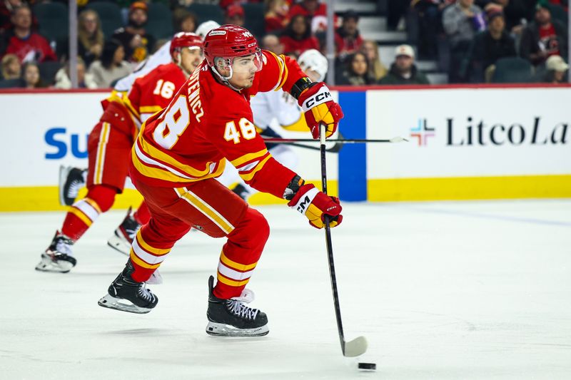 Jan 3, 2026; Calgary, Alberta, CAN; Calgary Flames defenseman Hunter Brzustewicz (48) passes the puck against the Nashville Predators during the first period at Scotiabank Saddledome. Mandatory Credit: Sergei Belski-Imagn Images