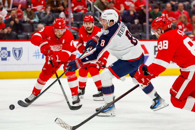 Mar 19, 2024; Detroit, Michigan, USA; Columbus Blue Jackets defenseman Zach Werenski (8) shoots the puck during the first period of the game against the Detroit Red Wings at Little Caesars Arena. Mandatory Credit: Brian Bradshaw Sevald-USA TODAY Sports