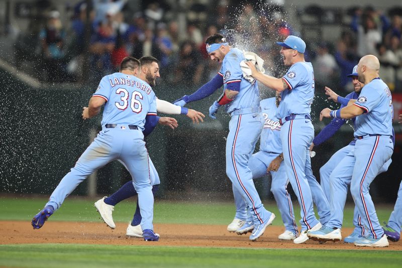 Apr 6, 2025; Arlington, Texas, USA; Texas Rangers catcher Jonah Heim (28) and his teammates celebrate after he singled in the winning run in the bottom of the ninth inning against the Tampa Bay Rays at Globe Life Field. Mandatory Credit: Tim Heitman-Imagn Images