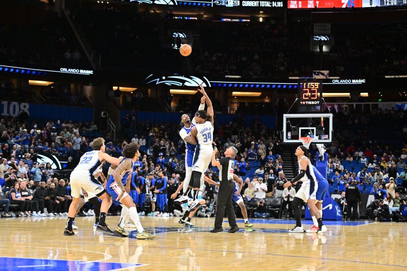 ORLANDO, FLORIDA - OCTOBER 18: Andre Drummond #5 of the Philadelphia 76ers and Wendell Carter Jr. #34 of the Orlando Magic tip-off a preseason game at Kia Center on October 18, 2024 in Orlando, Florida. NOTE TO USER: User expressly acknowledges and agrees that, by downloading and or using this photograph, User is consenting to the terms and conditions of the Getty Images License Agreement. (Photo by Julio Aguilar/Getty Images)