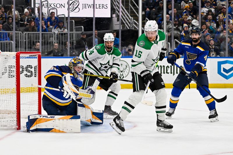 Dec 27, 2023; St. Louis, Missouri, USA;  St. Louis Blues goaltender Joel Hofer (30) defends the net against Dallas Stars center Joe Pavelski (16) and left wing Jamie Benn (14) during the third period at Enterprise Center. Mandatory Credit: Jeff Curry-USA TODAY Sports