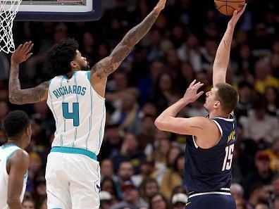 DENVER, COLORADO - JANUARY 01: Nikola Jokic #15 of the Denver Nuggets puts up a shot over Nick Richards #$ of the Charlotte Hornets in the third quarter at Ball Arena on January 01, 2024 in Denver, Colorado. NOTE TO USER: User expressly acknowledges and agrees that, by downloading and or using this photograph, User is consenting to the terms and conditions of the Getty Images License Agreement.   (Photo by Matthew Stockman/Getty Images)