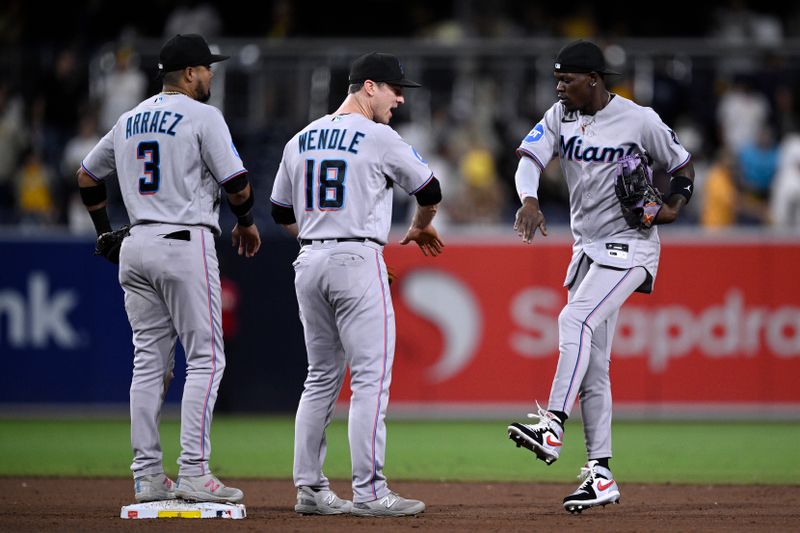 Aug 22, 2023; San Diego, California, USA; Miami Marlins center fielder Jazz Chisholm (right) celebrates with shortstop Joey Wendle (18) and second baseman Luis Arraez (3) after defeating the San Diego Padres at Petco Park. Mandatory Credit: Orlando Ramirez-USA TODAY Sports