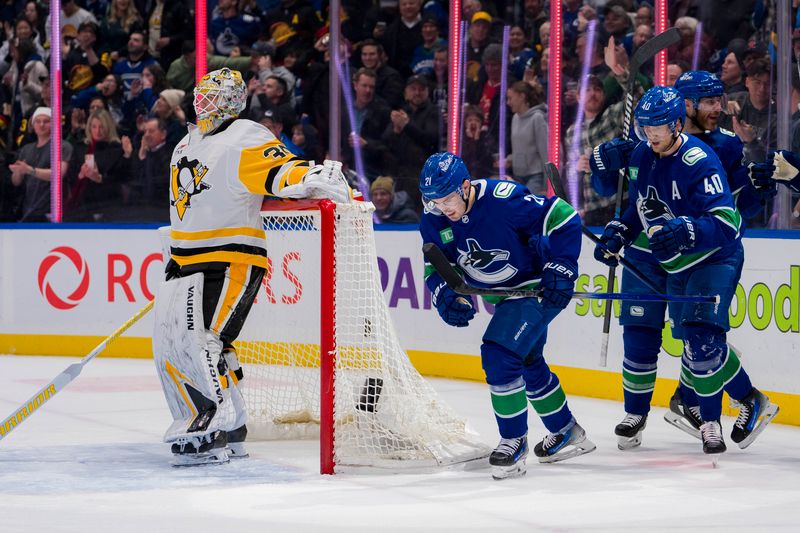 Feb 27, 2024; Vancouver, British Columbia, CAN; Pittsburgh Penguins goalie Tristan Jarry (35) looks away as Vancouver Canucks forward Nils Hoglander (21) and forward Elias Pettersson (40) and defenseman Ian Cole (82) celebrate Hoglander   s goal in the first period at Rogers Arena. Mandatory Credit: Bob Frid-USA TODAY Sports