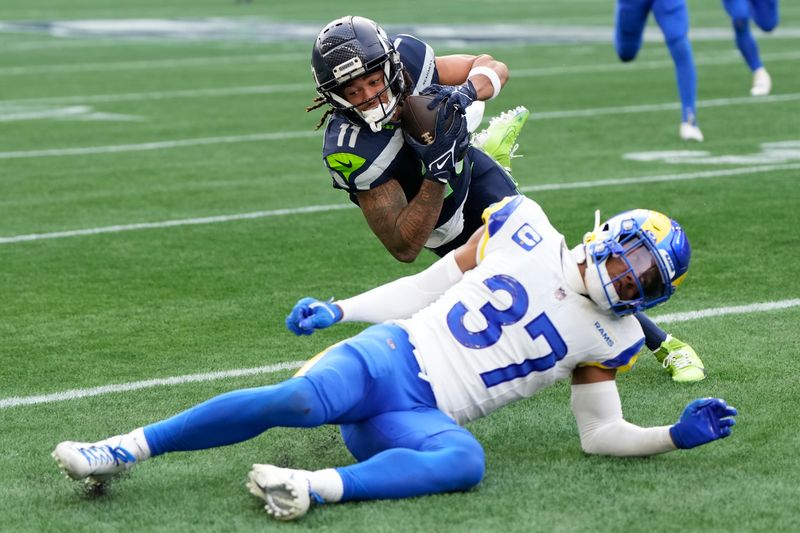 Seattle Seahawks wide receiver Jaxon Smith-Njigba (11) catches a pass against Los Angeles Rams safety Quentin Lake (37) during the first half of an NFL football game in Seattle, Sunday, Nov. 3, 2024. (AP Photo/Stephen Brashear)