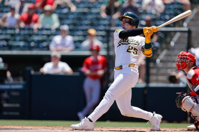 May 22, 2025; West Sacramento, California, USA; Athletics right fielder Brent Rooker (25) hits a two run home run during the first inning against the Los Angeles Angels at Sutter Health Park. Mandatory Credit: Sergio Estrada-Imagn Images