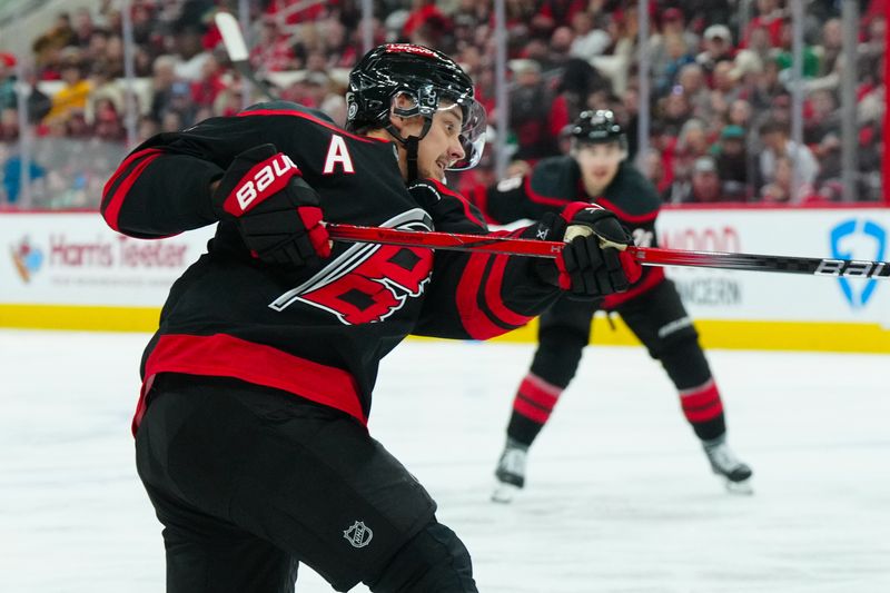 Nov 25, 2024; Raleigh, North Carolina, USA;  Carolina Hurricanes center Sebastian Aho (20) takes a shot against the Dallas Stars during the third period at Lenovo Center. Mandatory Credit: James Guillory-Imagn Images