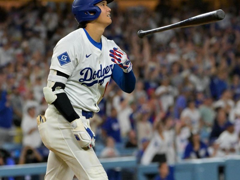Sep 16, 2025; Los Angeles, California, USA;  Los Angeles Dodgers designated hitter Shohei Ohtani (17) flips his bat after hitting his 50th home run of the season during the eighth inning against the Philadelphia Phillies at Dodger Stadium. Mandatory Credit: Jayne Kamin-Oncea-Imagn Images