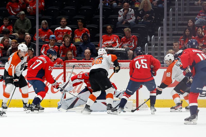 Sep 22, 2024; Washington, District of Columbia, USA; Philadelphia Flyers forward Morgan Frost (48) scores a goal on Washington Capitals goaltender Clay Stevenson (33) in the third period at Capital One Arena. Mandatory Credit: Geoff Burke-Imagn Images