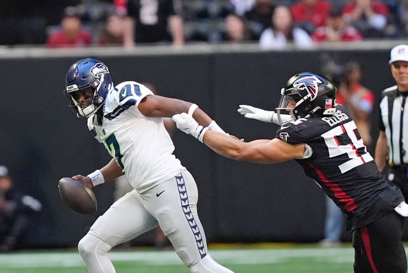 Seattle Seahawks quarterback Geno Smith (7) escapes from Atlanta Falcons linebacker Kaden Elliss (55) during the first half of an NFL football game, Sunday, Oct. 20, 2024, in Atlanta. (AP Photo/ Brynn Anderson )