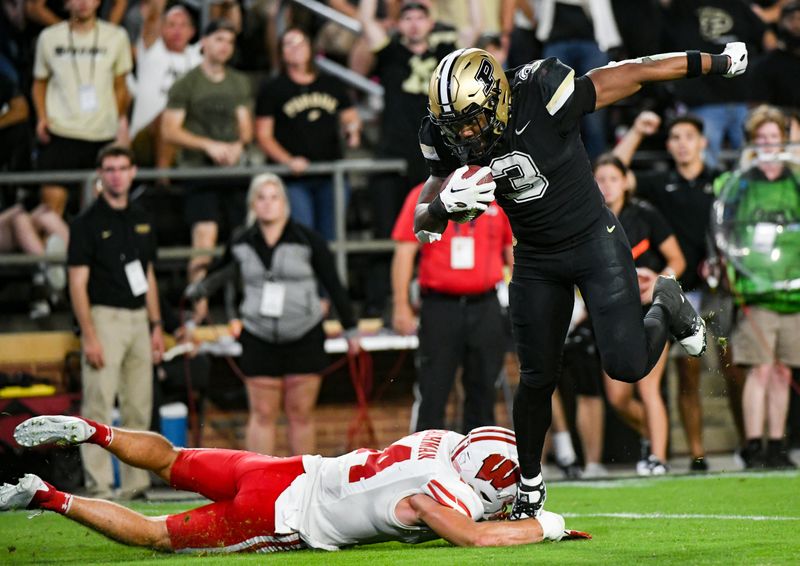 Sep 22, 2023; West Lafayette, Indiana, USA; Purdue Boilermakers running back Tyrone Tracy Jr. (3) evades a tackle from Wisconsin Badgers safety Preston Zachman (14) on his way to scoring a touchdown during the second half at Ross-Ade Stadium. Mandatory Credit: Robert Goddin-USA TODAY Sports