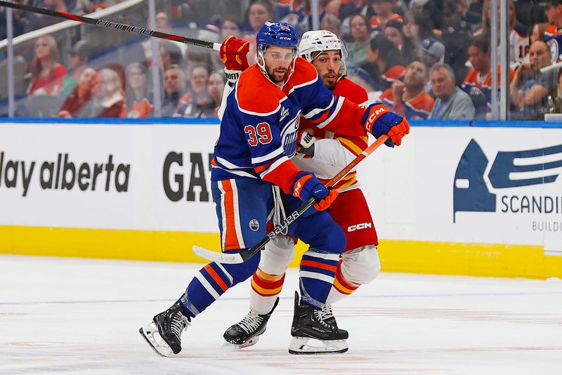 Sep 21, 2025; Edmonton, Alberta, CAN; Edmonton Oilers forward Seth Griffith (39) and Calgary Flames forward Ryan Lomberg (70) battle for position during the second period at Rogers Place. Mandatory Credit: Perry Nelson-Imagn Images