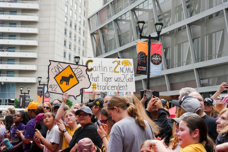 Apr 2, 2023; Dallas, TX, USA; Iowa fans hold signs in support of Iowa Hawkeyes guard Caitlin Clark prior to the game between the LSU Lady Tigers and the Iowa Hawkeyes during the final round of the Women's Final Four NCAA tournament at the American Airlines Center. Mandatory Credit: Kirby Lee-USA TODAY Sports